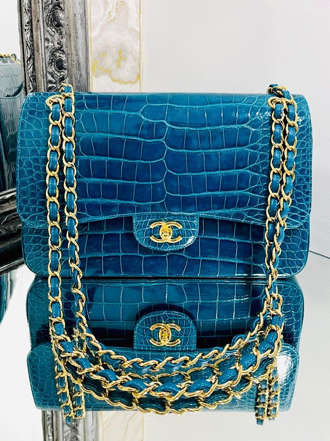 Chanel Alligator Jumbo Double Flap Timeless Bag 

Shiny blue/turquoise exotic skin bag with gold hardware.

Iconic strap and 'CC' twist lock closure.

This is a very rare bag.....

Size - Height 20cm, Width 30cm, Depth 10cm 

Condition -