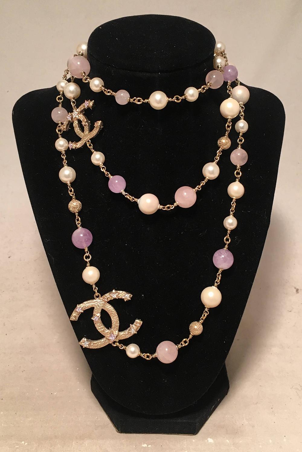 Chanel Amethyst Rose Quartz and Pearl Crystal CC Beaded Necklace in excellent condition. Cream pearls, pink rose quartz and purple amethyst beads strung together with gold chain hardware. 2 gold CC logo embellished charms feature delicate stars with