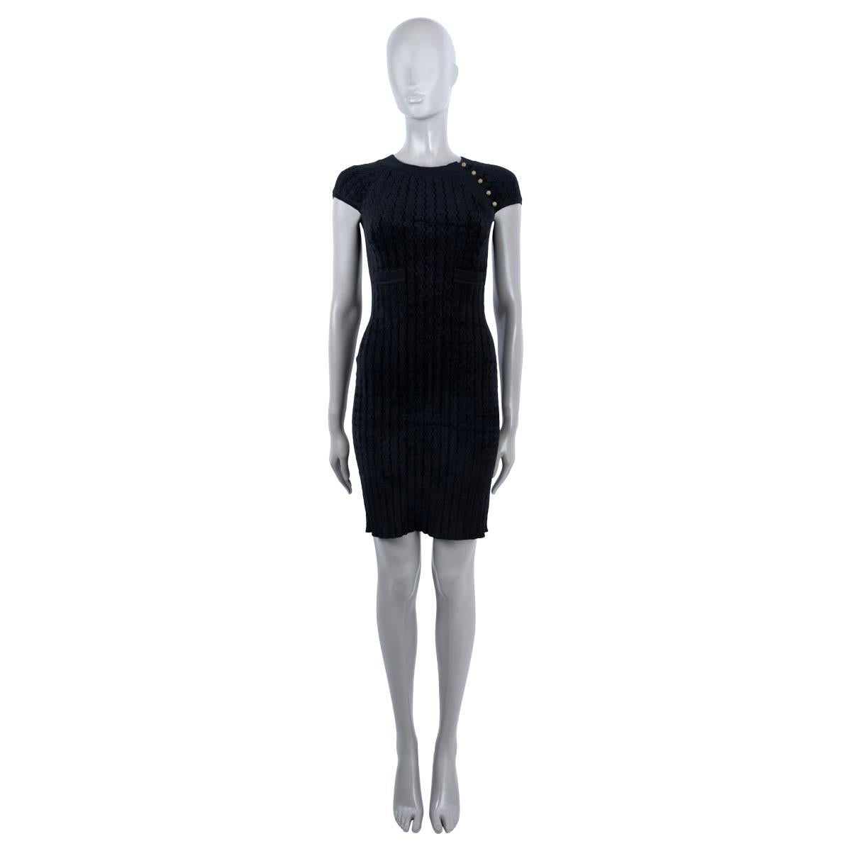 100% authentic Chanel cap sleeve rib knit dress in black viscose (63%) and polyamide (27%). Features 2 pockets on the front. Opens with five CC buttons at the neck. Has been worn and is in excellent condition.

2010 Paris-Shanghai Metiers d'Art