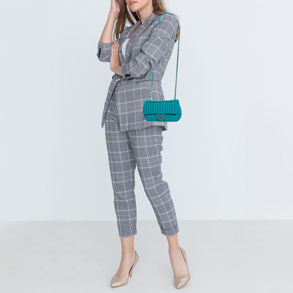 The monumental place that Chanel flap bags hold in the history of fashion is note-worthy. So, treat yourself with one such creation from the label. Here is a petite bag made from jersey and accentuated with vertical quilts all over. The flap is