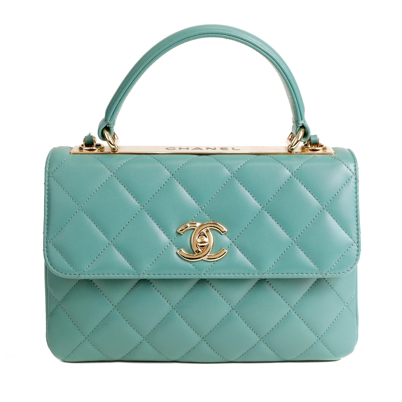 This authentic Chanel Aqua Lambskin Trendy CC Top Handle Bag is in pristine condition.  A beautiful classic, the Trendy CC is a ladylike silhouette certain to enhance any collection.  
Soft aqua green lambskin is quilted in signature Chanel diamond