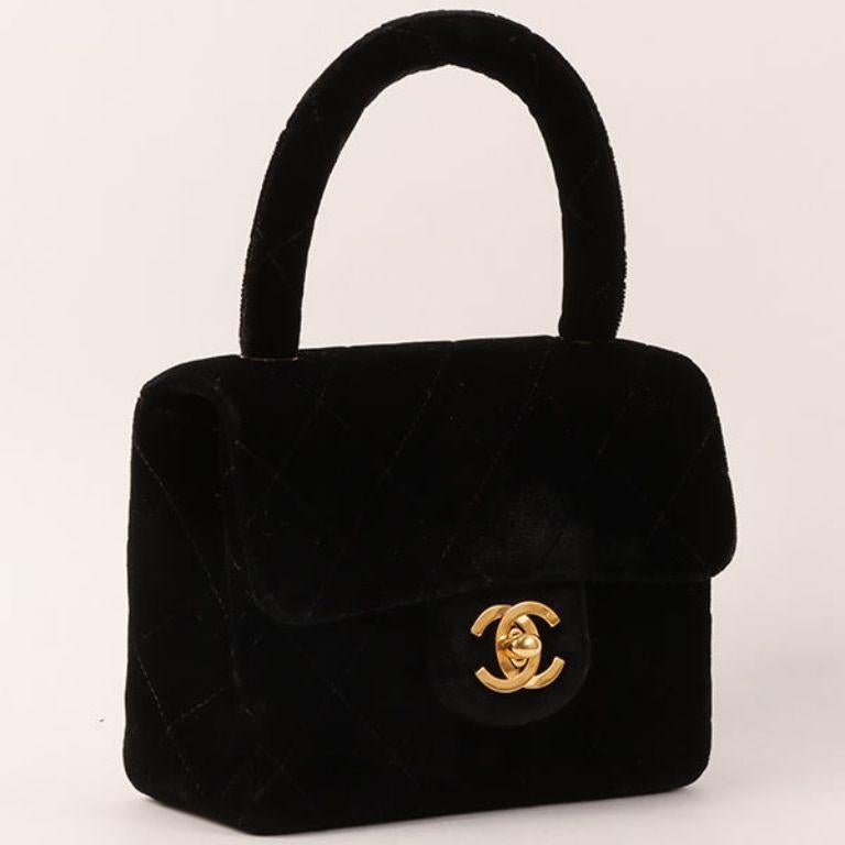 Chanel Around 1992 Made Velour Classic Flap Top Handle Bag Mini Black

Additional information:
Measurements: H 10 x W 14 x D 5 cm 
Handle: 23 cm

This item has been used and may have some minor flaws.