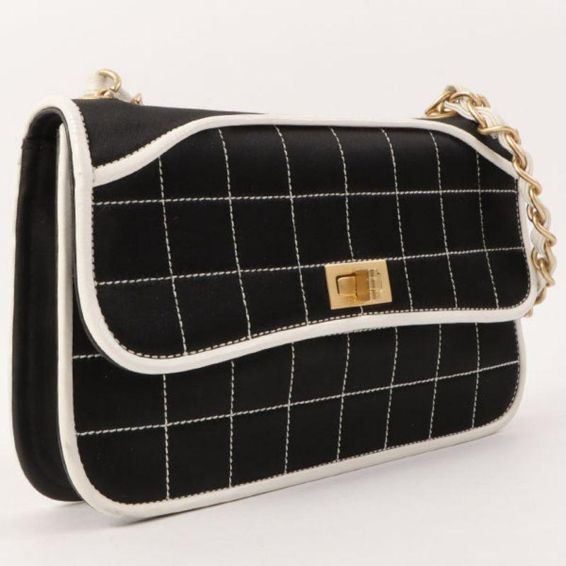 Chanel Around 2000 Made Silk Satin Bicolor 2.55 Chain Top Handle Bag Black/White

Additional information:
Measurements: 22 W x 2 D x 14 H cm
Handle 46cm
Condition: Good
This item has been used and may have some minor flaws. Before purchasing, please