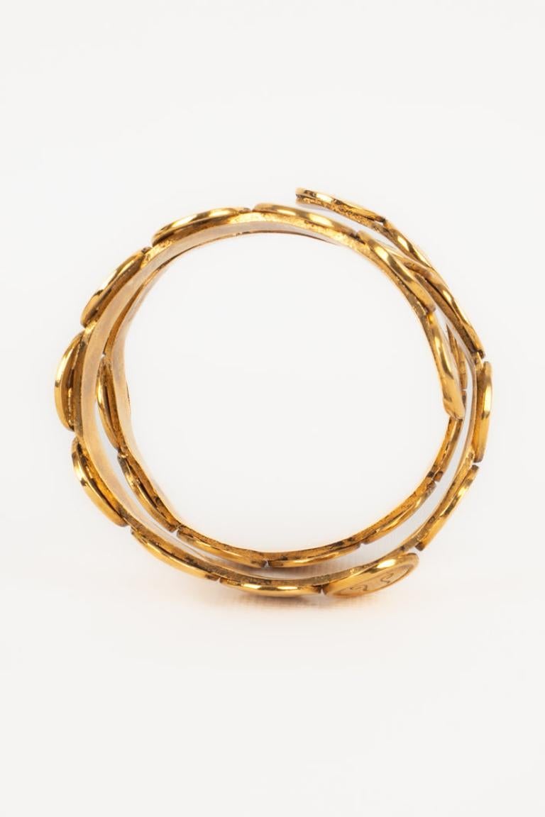Chanel Astrologie Goldenes Spiralarmband aus Metall, 1990er-Jahre im Angebot 1