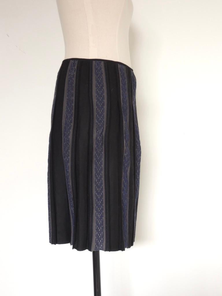 Elegant Chanel wool blend skirt in black with vertical panels of blue and grey with metallic accents. The tag indicates that this is from Autumn 2005.

The skirt is tagged size 42.

This has the original tags attached. I don't know if it was ever