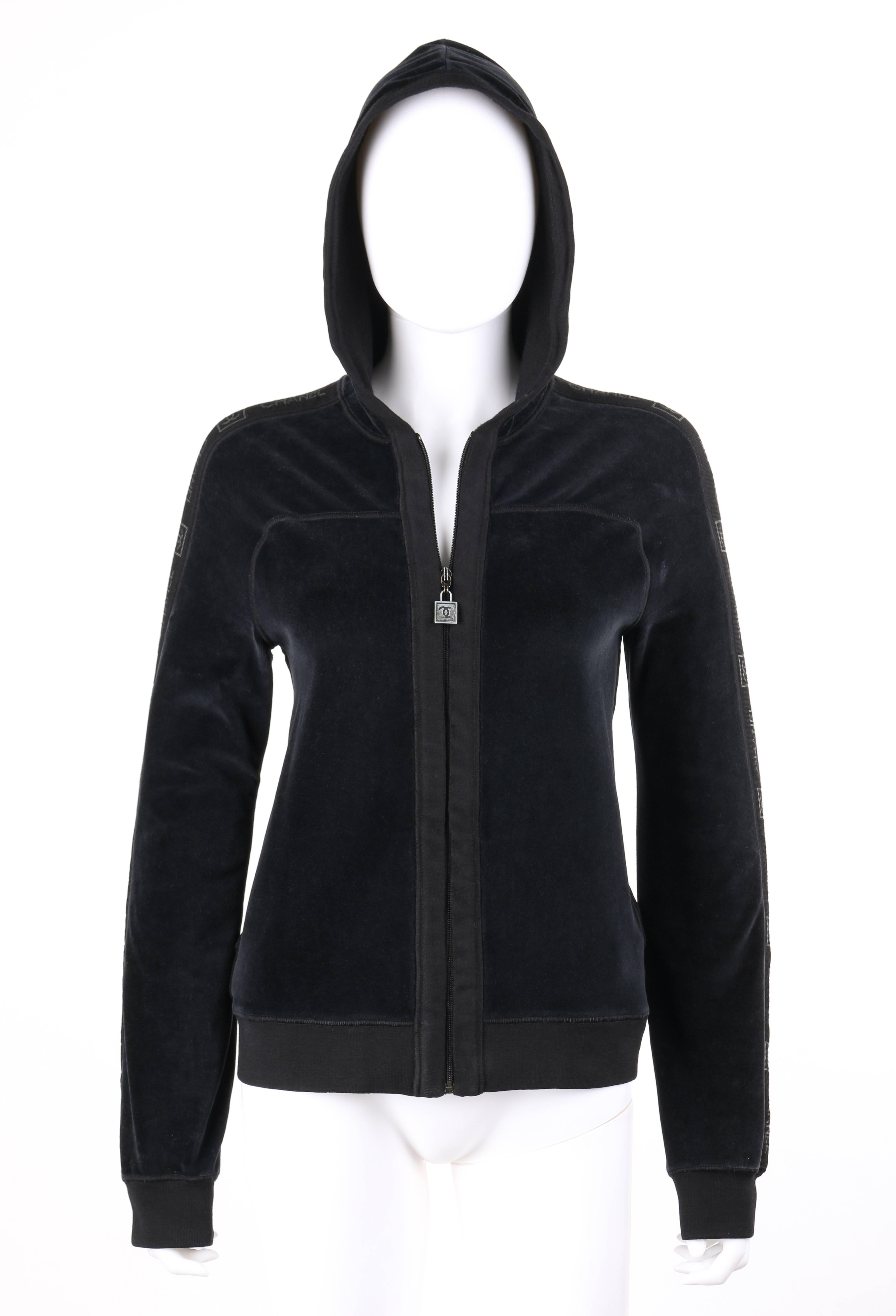 Chanel Autumn / Winter 2005 black velour zip up signature hooded track jacket active wear. Designed by Karl Lagerfeld. Black cotton velour knit. Center front zipper closure with gun metal square 