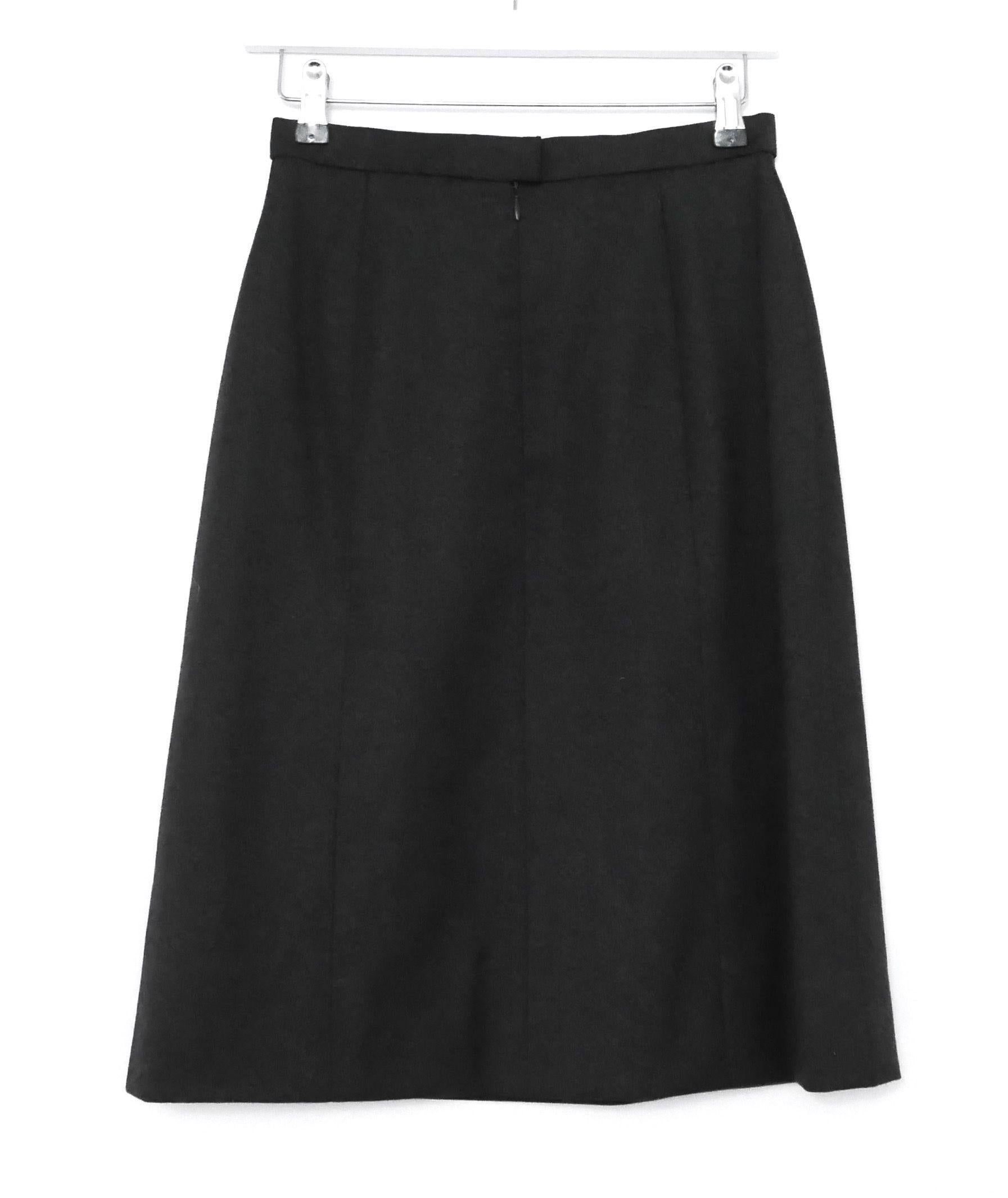 Classic, timeless skirt from the Chanel Fall 1996 Collection. Worn just once and then carefully stored. Made from fine, dark grey wool flannel, it has a classic pencil cut with vertical panels, CC embossed full silk lining and concealed back zip.
