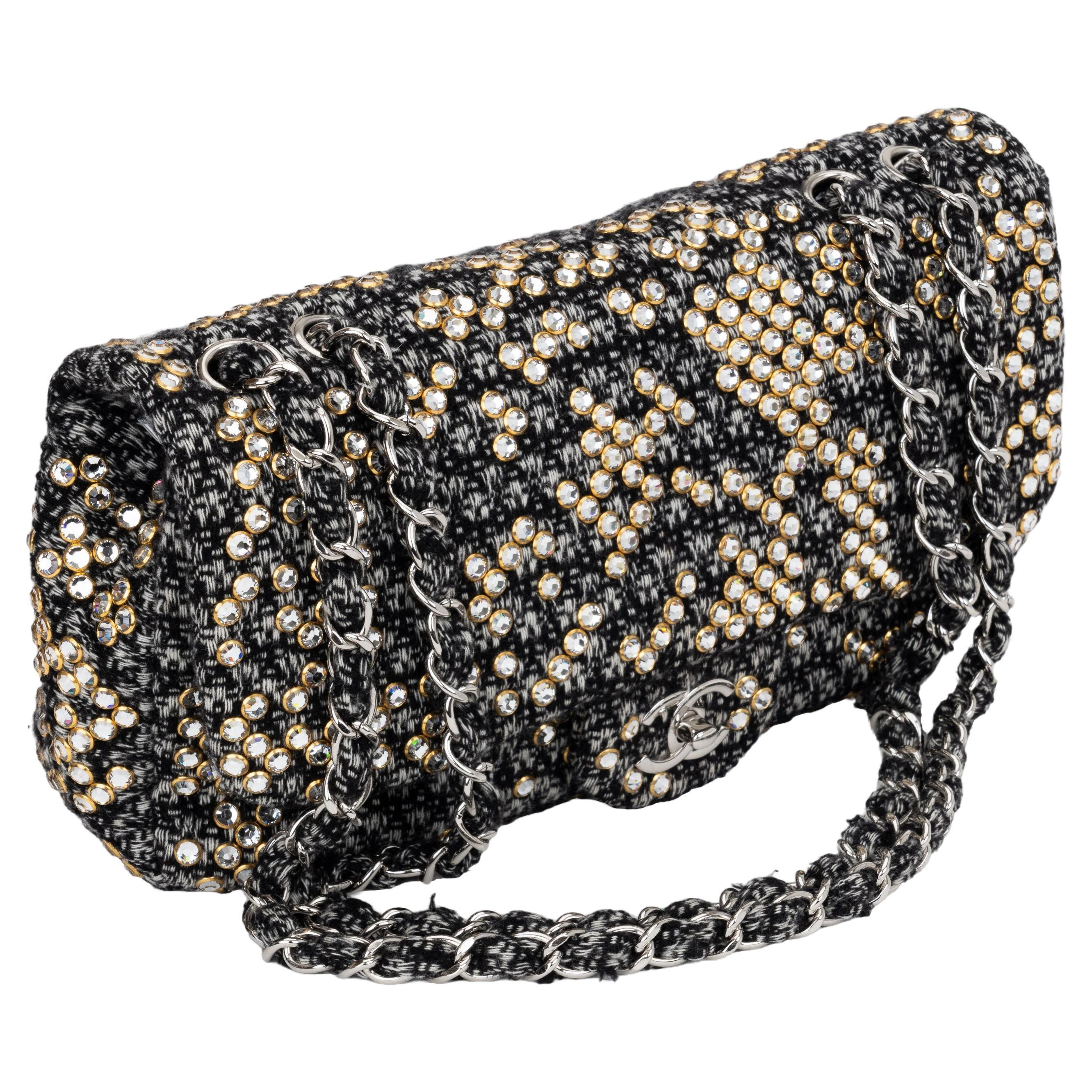 Black and white Chanel tweed classic single flap shoulder bag. Accented with Swaroski crystals, Dual chain shoulder straps. Shoulder drop 13