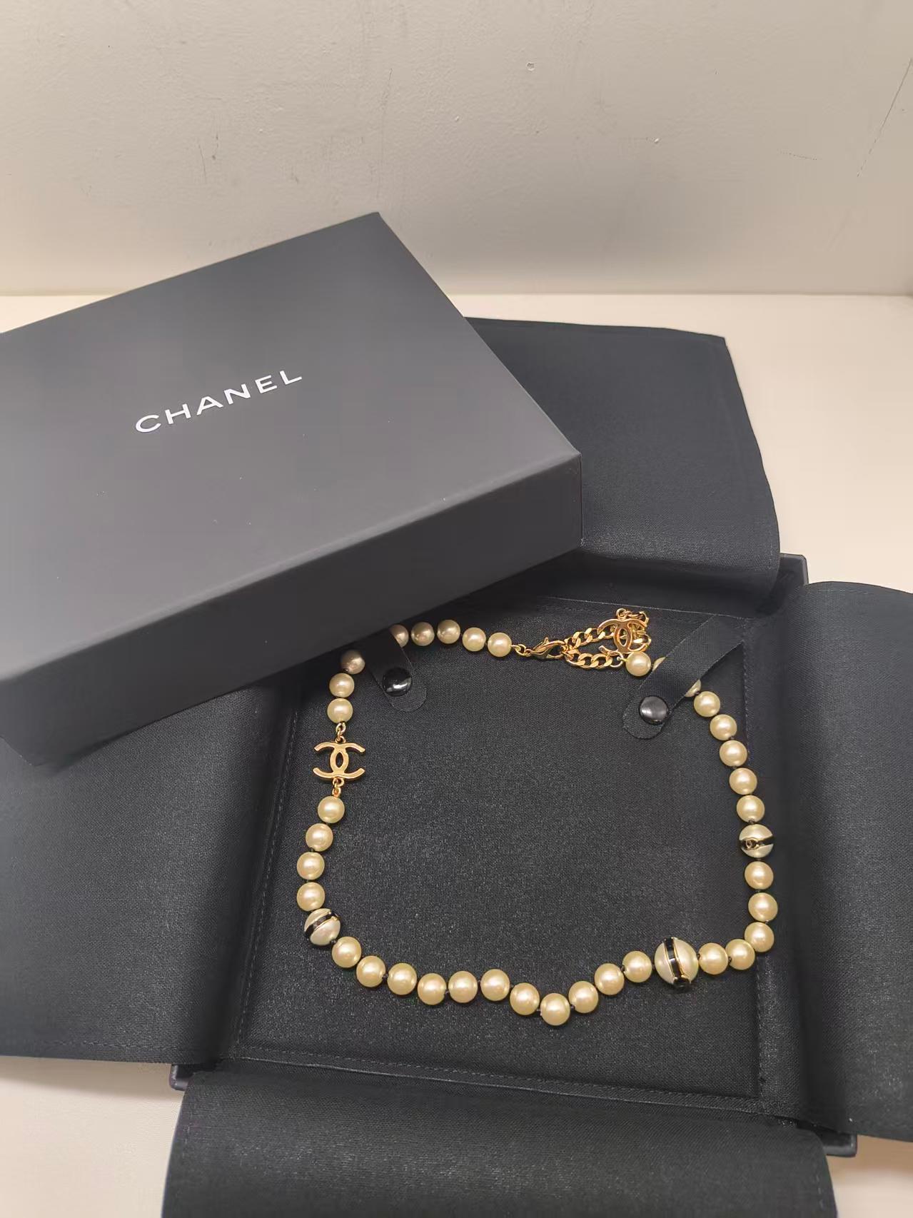 Questo girocollo Chanel è un pezzo elegante e senza tempo che combina le classiche perle con il lusso tipico del marchio. Caratterizzata da uno splendido filo di perle finte color crema, la collana è impreziosita da accenti dorati con logo Chanel