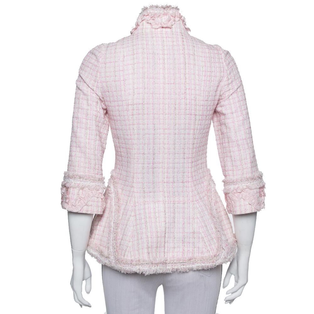 Creations from Chanel leave no stone unturned for us to get impressed and this jacket does the same! The baby pink tweed creation features standing collars, front button fastenings, long sleeves, and fringed trims. It is sure to lend you a great fit