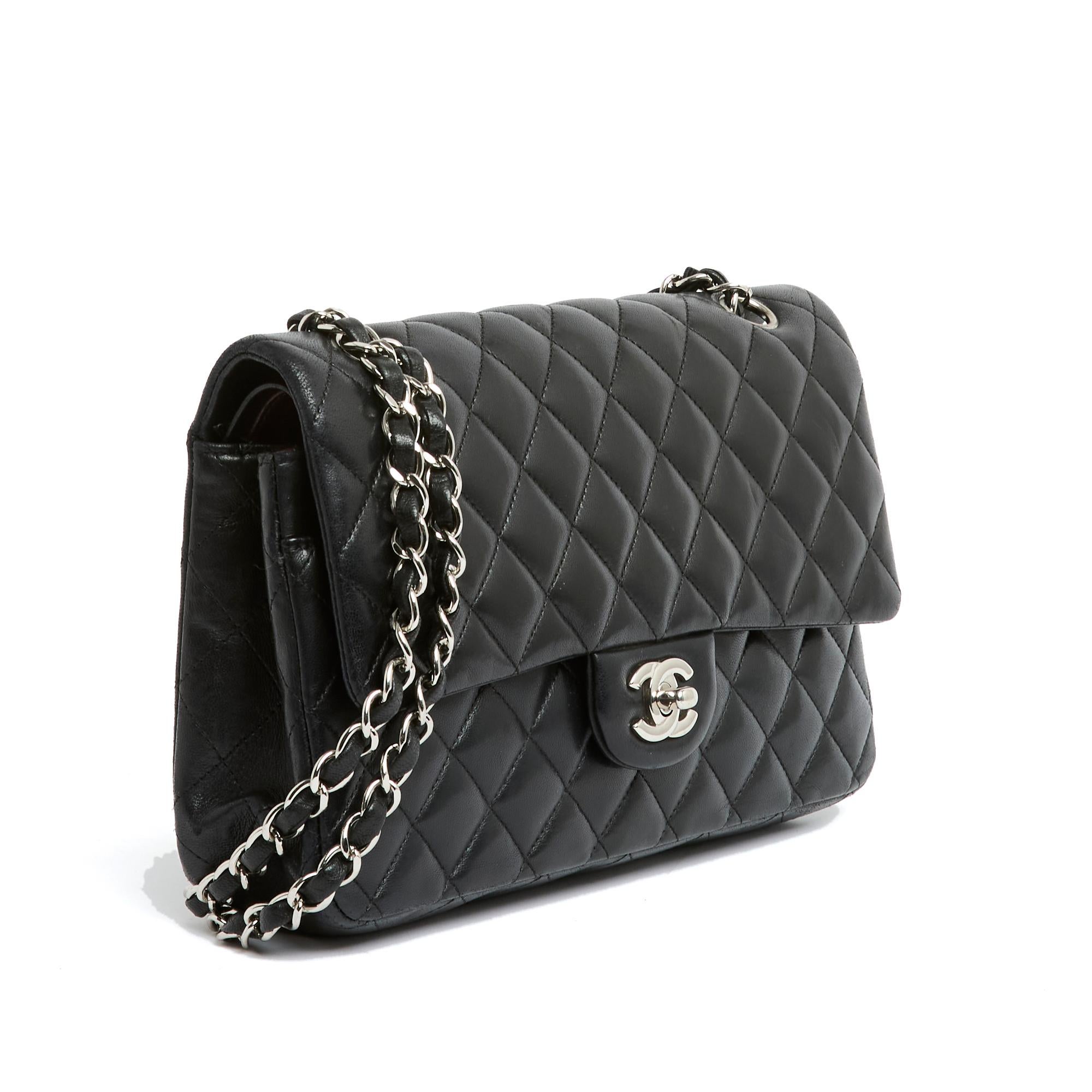 Chanel bag, Classic line, Double Flap model, 26 cm format, in quilted black leather, silver metal CC clasp, silver metal chain strap for shoulder or cross body wear, burgundy leather interior with a double patch pocket, large patch pocket on the