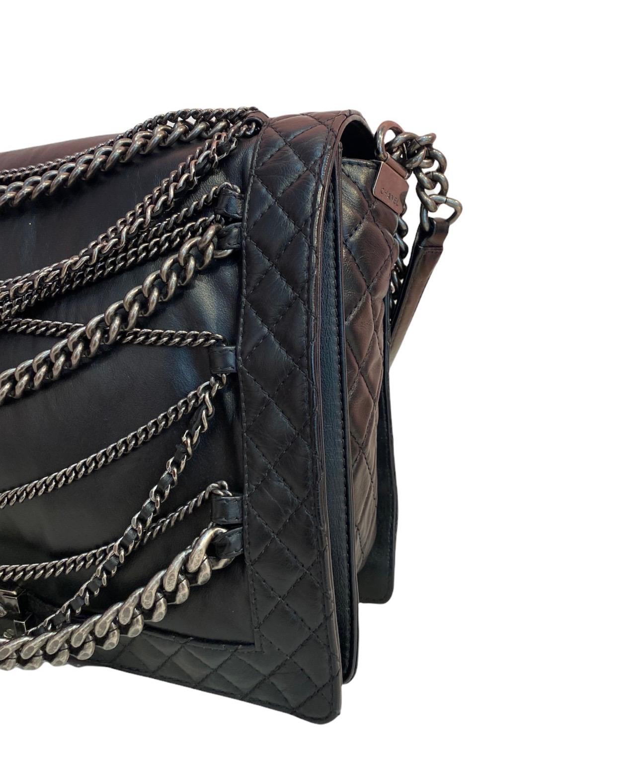 Limited Edition Chanel Multi Chain XL bag in black leather with silver hardware.  Features a front flap with CC interlocking closure. The interior is lined with a black fabric.  The bag is equipped with a silver chain shoulder strap with a leather