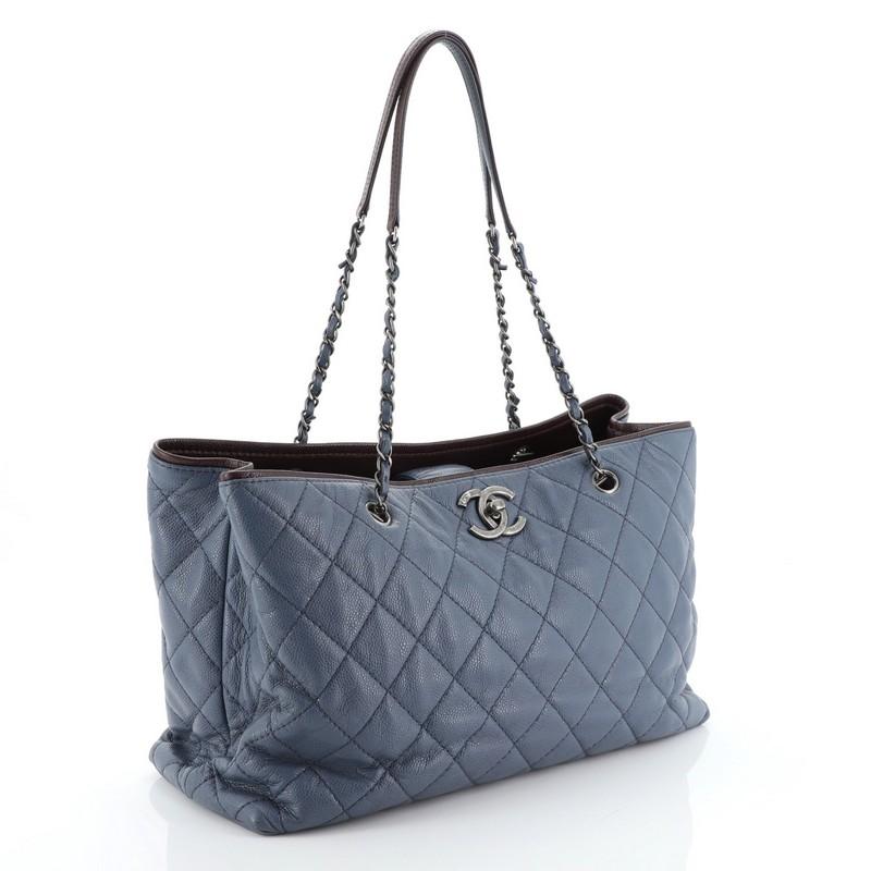This Chanel Be Caviar Tote Quilted Caviar Large, crafted in blue quilted caviar leather, features woven-in leather chain straps with leather pads and aged silver-tone hardware. Its CC turn-lock closure opens to a red leather interior. Hologram