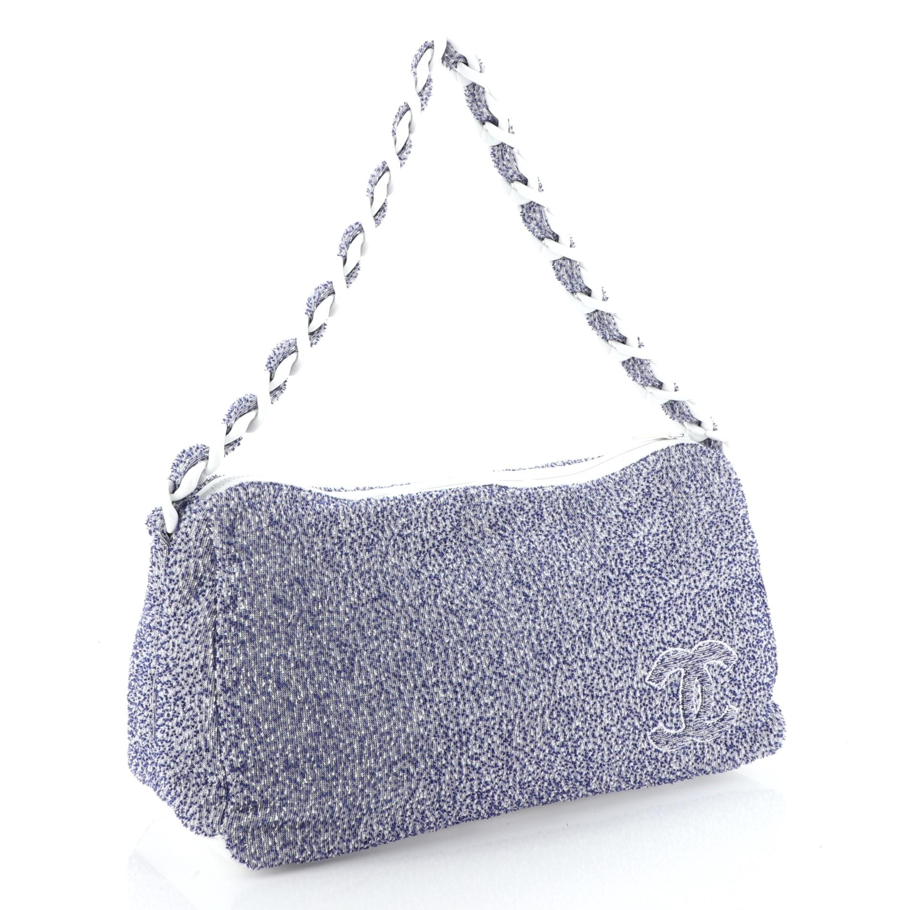 This Chanel Beach Resin Chain Hobo Terry Cloth Large, crafted in blue terry cloth, features woven-in fabric resin chain-link strap and CC logo. Its zip closure opens to a white fabric interior.

Estimated Retail Price: $1,700
Condition: Great. Minor