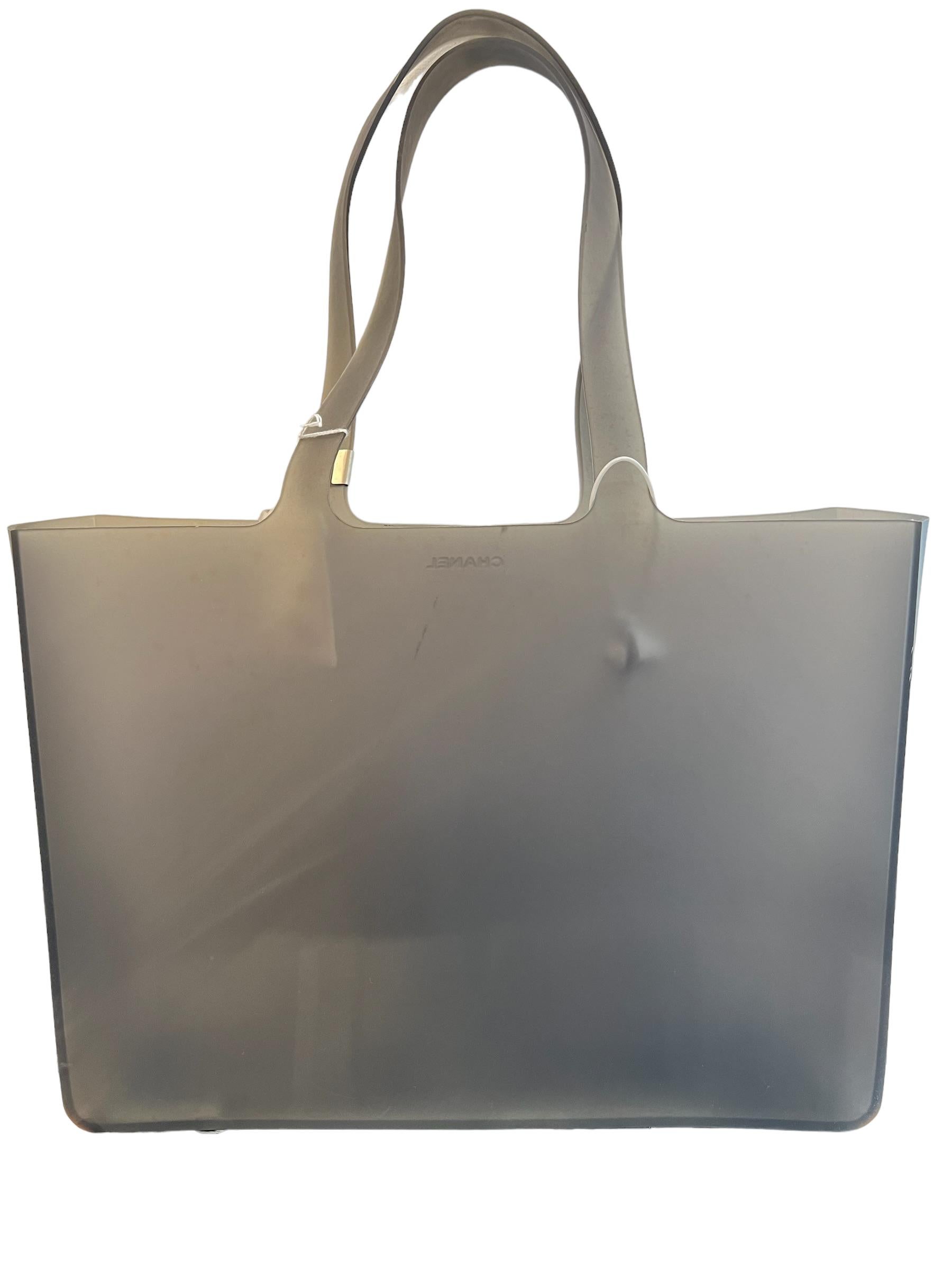 Chanel Beach 2010s debossed-logo tote bag from Chanel Pre-Owned featuring debossed logo to the front, silver-tone hardware, two long top handles, main compartment and circa 2010s. POSITIVELY CONSCIOUS: Purchasing this item continues its narrative