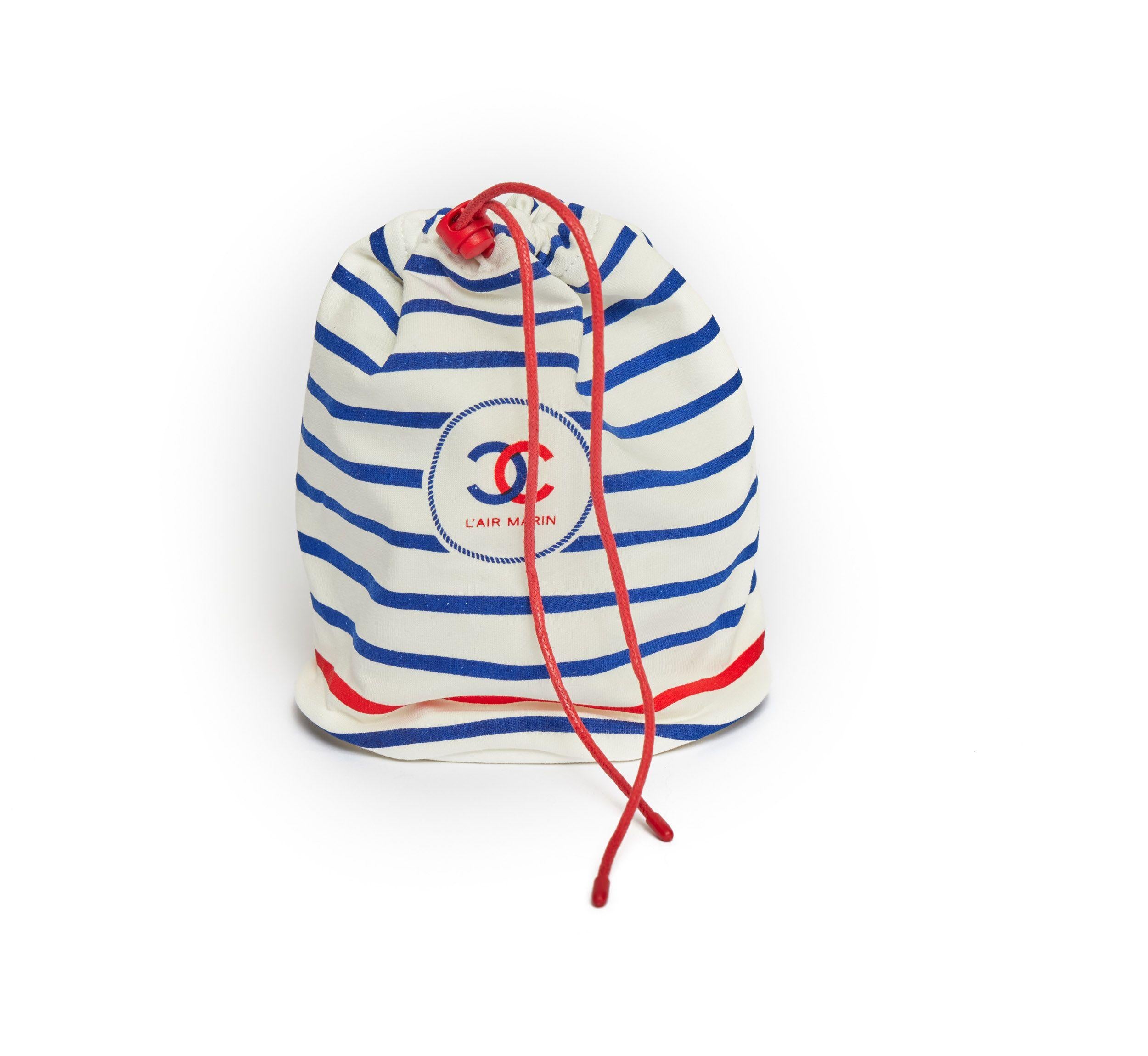 Chanel Beauty Case from the L'Air Marin collection. This item were never for sale and only for VIP clients. It has never been used. The bag is made out of cotton and spandex. It is in a maritime style with blue stripes and one red stripe at the