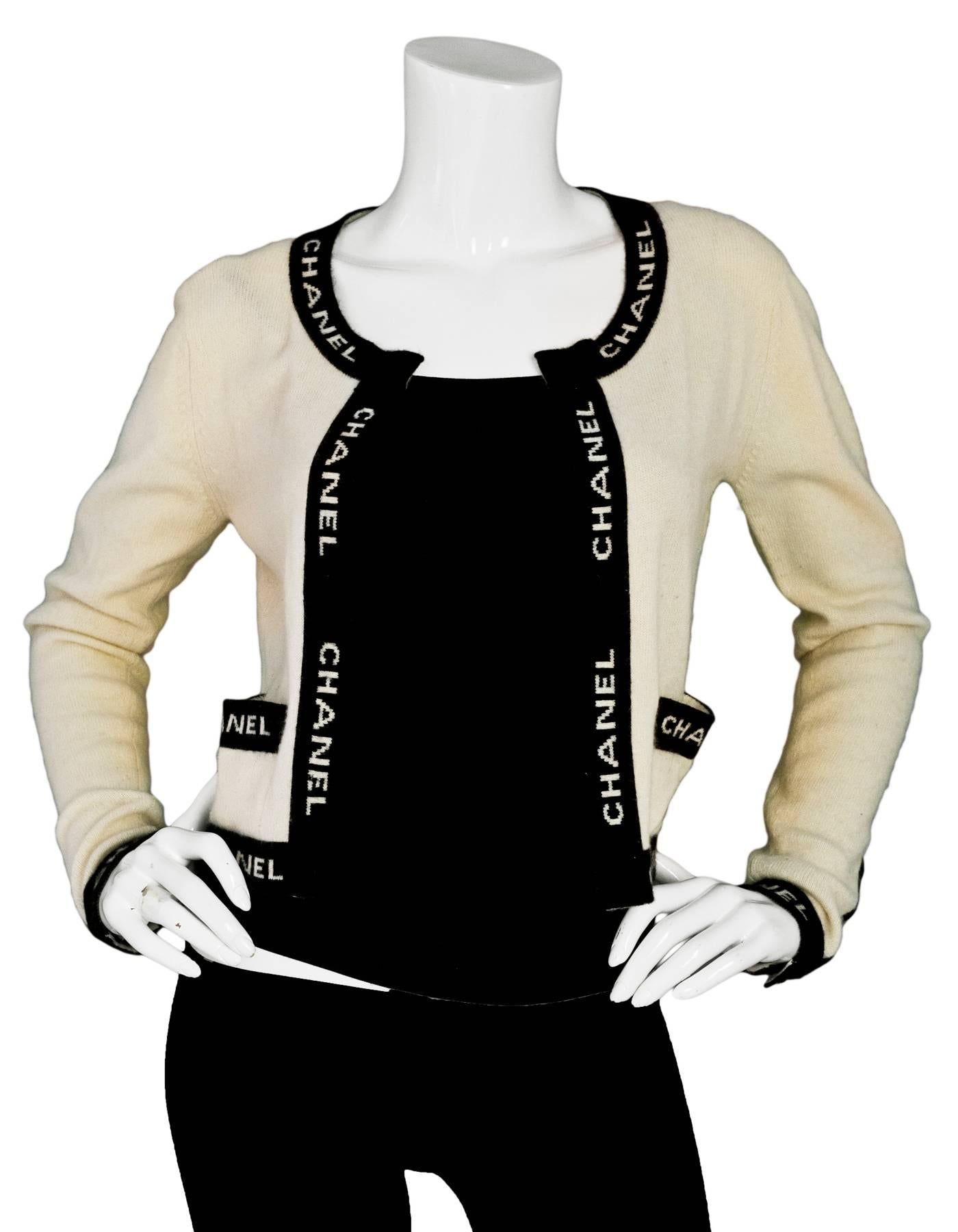 Chanel Beige & Black CHANEL Sweater

Color: Beige, black
Materials: not listed, feels like cashmere
Lining: None
Closure/Opening: Open front
Exterior Pockets: Flat pockets
Overall Condition: Very good pre-owned condition with the exception of some