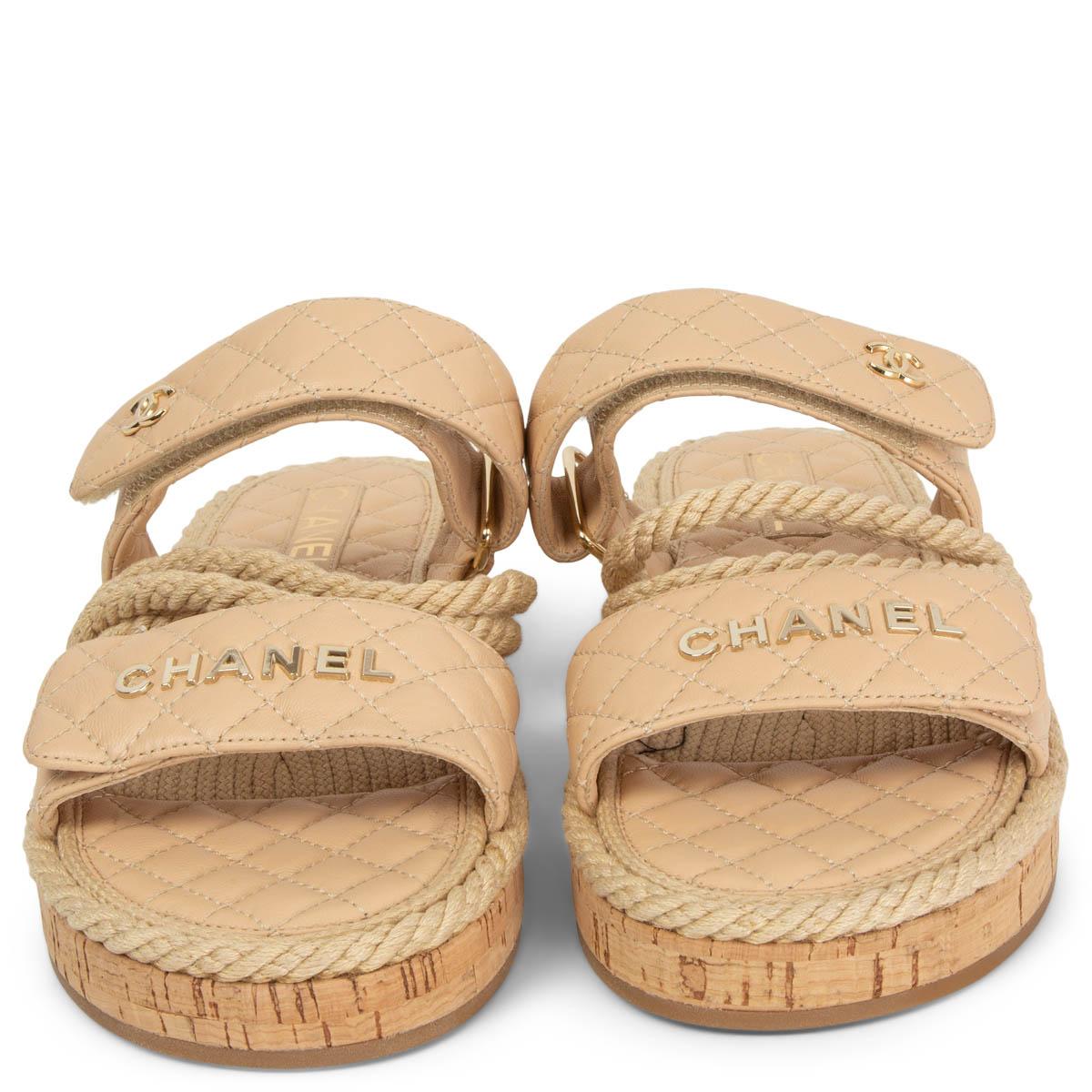 100% authentic Chanel 2021 Dad Sandals in light beige quilted lambskin with raffia details and a cork sole. Brand new. 

Measurements
Model	Chanel21S
Imprinted Size	40
Shoe Size	40
Inside Sole	26cm (10.1in)
Width	8cm (3.1in)
Heel	3cm (1.2in)

All