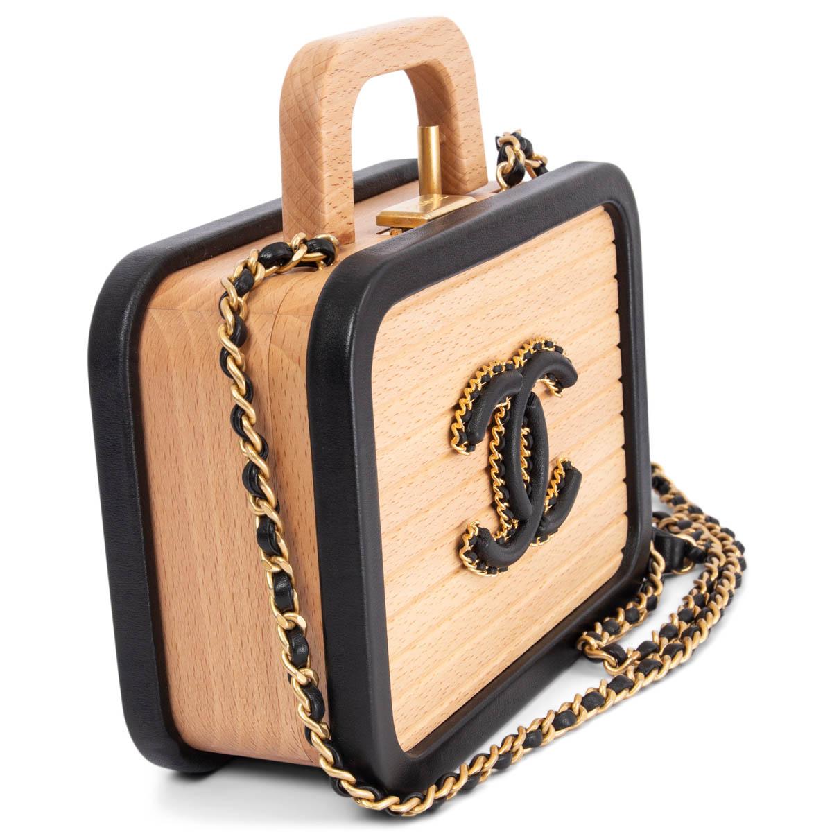 100% authentic Rare limited edition Chanel Small Vanity bag in beige beech wood with black leather trims and antique gold-tone hardware. Opens with a logo clasp closure and is lined in black quilted calfskin and wood with one quilted classic flap