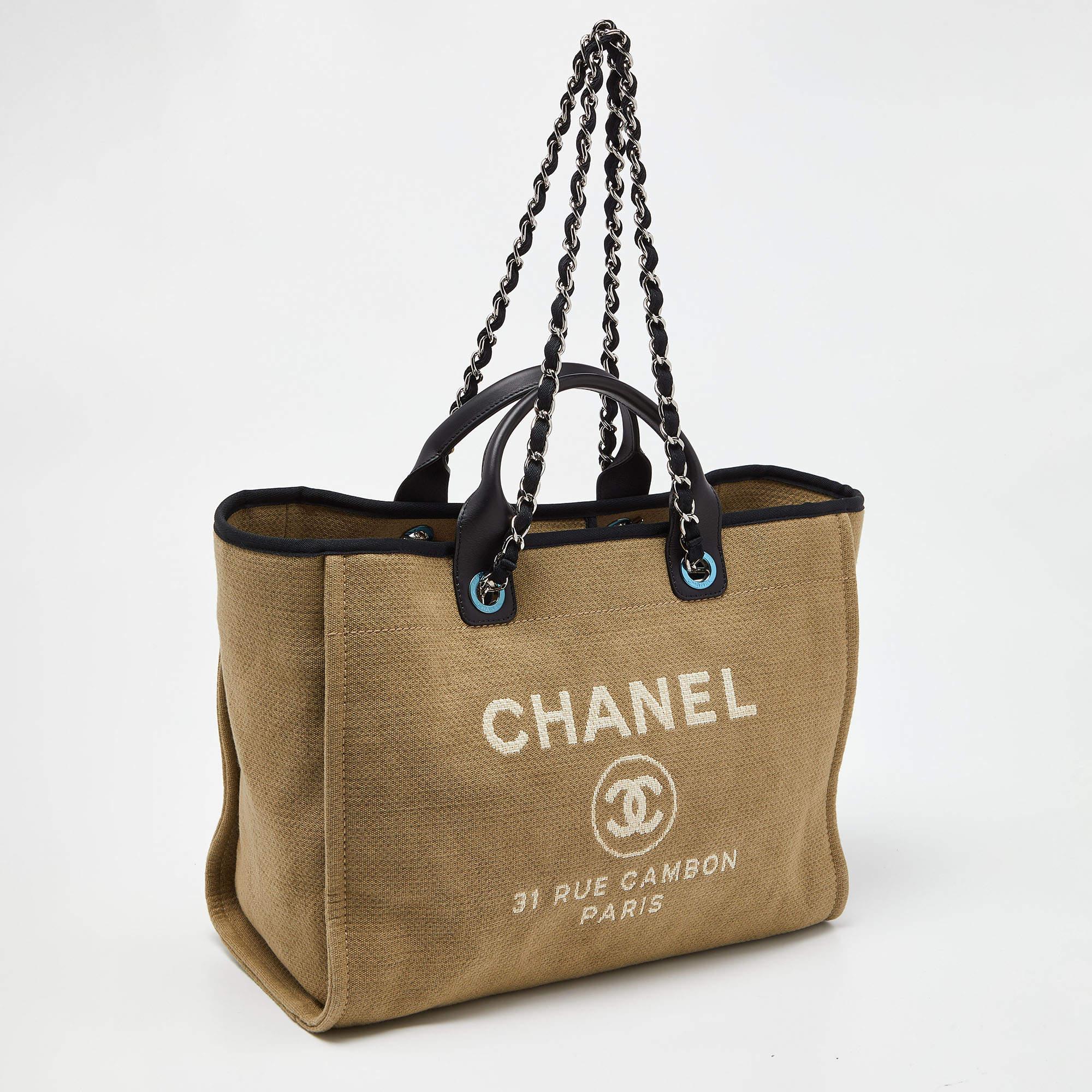 This Deauville shopper tote from Chanel is truly beautiful in every way! It has been designed using canvas and leather on the exterior with a logo print detail decorating the front. Its large, sturdy shape is supported by dual handles and a woven