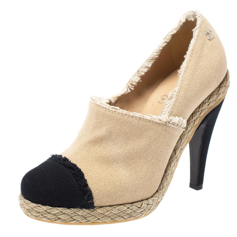 Mixing the design of the famous espadrilles into booties, this pair by Chanel brings the delight of two styles. They have been crafted from canvas and feature contrasting black cap toes, fringed toplines, espadrille midsoles, and 10 cm