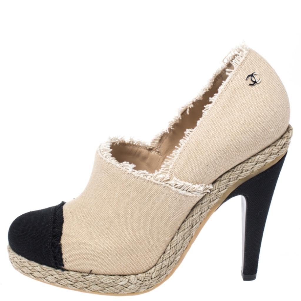 Mixing the design of the famous espadrilles into booties, this pair by Chanel brings the delight of two styles. They have been crafted from canvas and feature cap toes, fringed edges and 12 cm heels.

Includes: Original Box, Info Booklet, Original