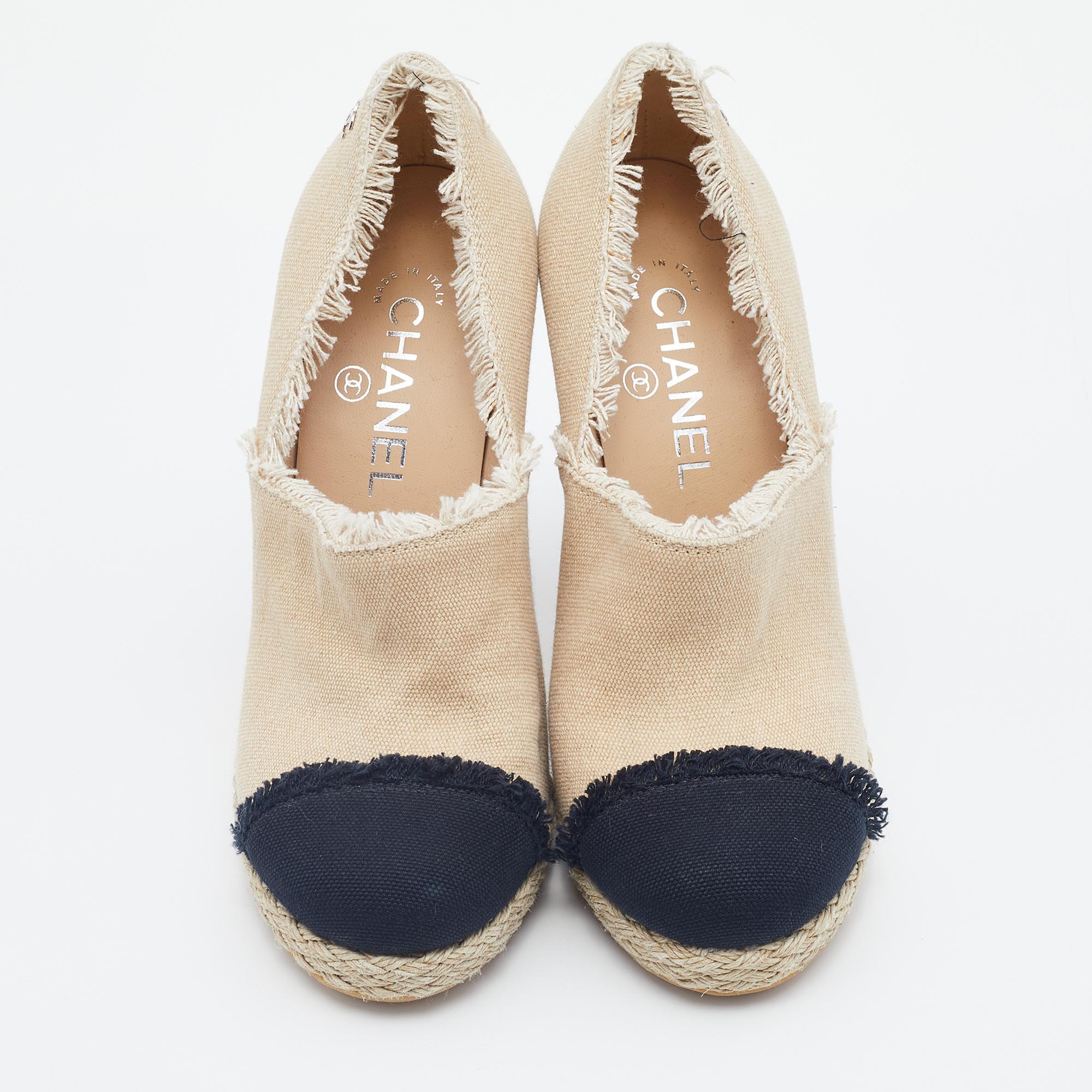 Mixing the design of the famous espadrilles into booties, this pair by Chanel brings the delight of two styles. They have been crafted from canvas and feature contrasting black cap toes, fringed toplines, espadrille midsoles, and 11.5cm heels.


