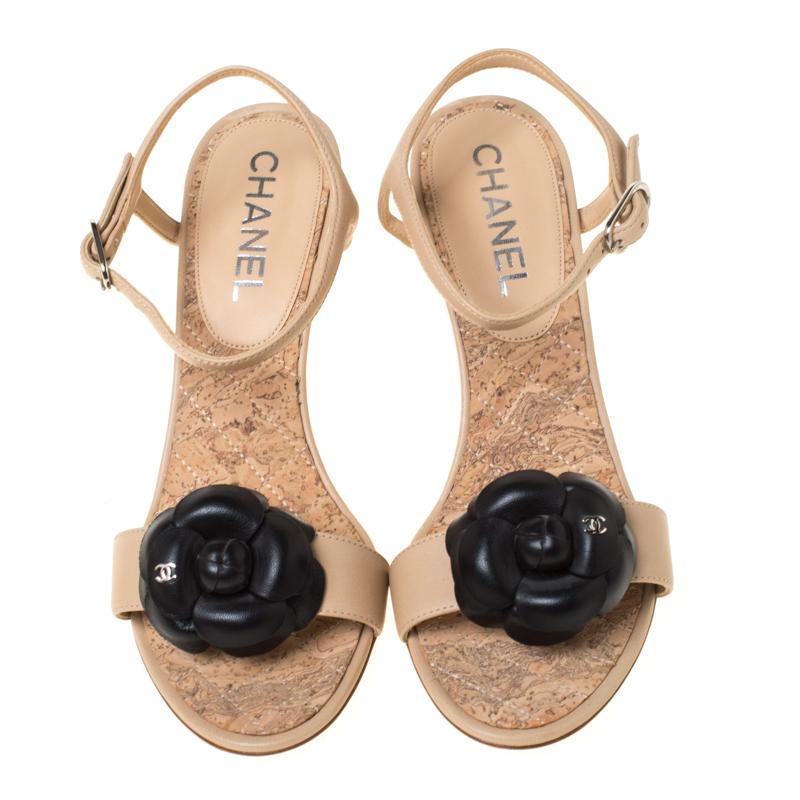 Charm your way to all your social gatherings in this pair of sandals from Chanel. Crafted from leather, they carry a feminine silhouette with a Camellia perched on the front, buckle-held slingback and a quilted wedge heel. The gorgeous flowers are