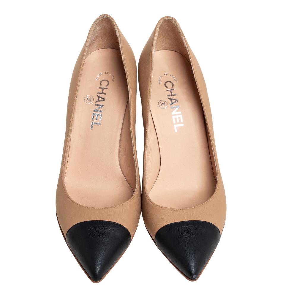 These fabulous pumps from Chanel will lend a luxurious appeal to your looks. They are crafted from beige and black leather and feature CC logo detailed pointed cap toes. They come equipped with comfortable leather-lined insoles and stand tall on 8.5