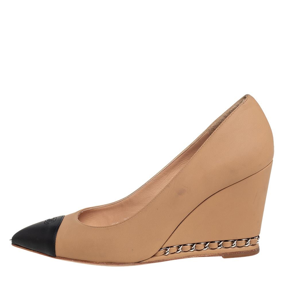 These fabulous pumps from Chanel will lend a luxurious appeal to your looks. They are crafted from beige and black leather and feature CC logo detailed pointed cap toes. They come equipped with comfortable leather-lined insoles and stand tall on 8.5