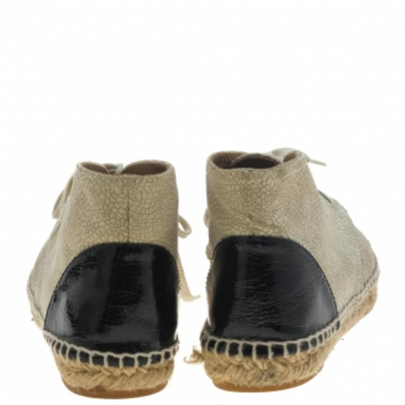 One's wardrobe is incomplete without a good pair of sneakers. If you're looking for a pair, we recommend these Chanel ones! These high-top Chanel sneakers have been crafted using beige textured leather and black patent leather. They are complete