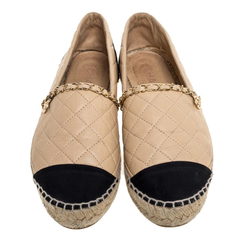 These comfortable espadrilles from Chanel are designed for effortless style. They feature braided midsoles with beige quilted uppers, a leather woven chain detail with the CC logo and black cap toes & counters. They are chic, versatile and an