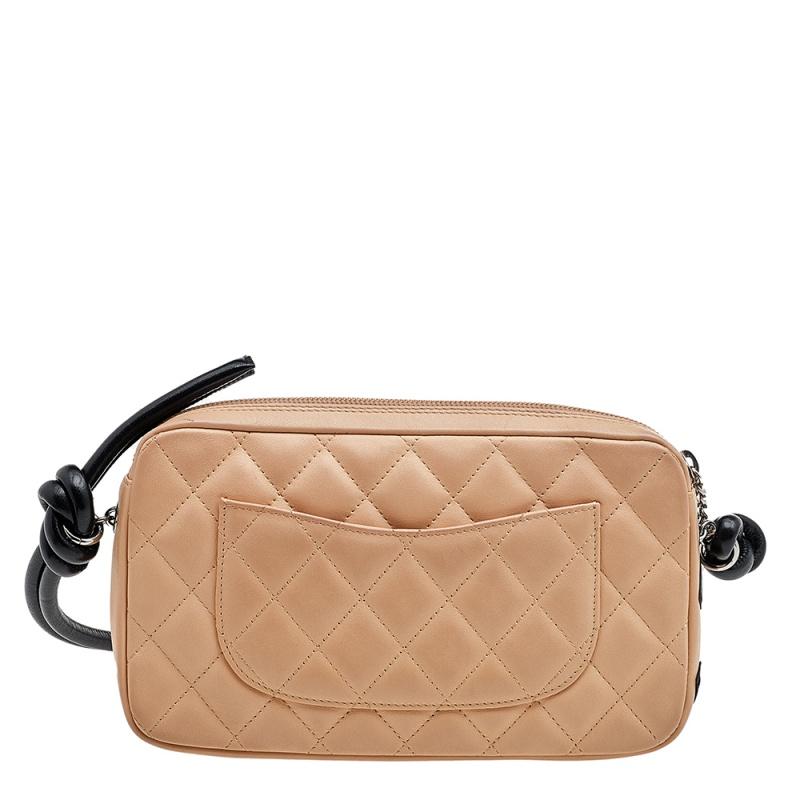 Chanel's unmatched aesthetics combined with unending glamour gives us this wonderful creation. This Ligne Cambon pochette from Chanel is made from black-beige quilted leather, with a CC detail adorning its front. It has silver-tone hardware and a