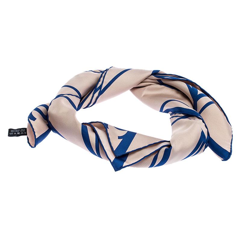 Beautifully cut from 100% silk, this Chanel scarf features a beige & blue CC geometric print all over and hemmed edges. Make this gorgeous scarf yours today, and flaunt it like a fashionista!

Includes: The Luxury Closet Packaging

