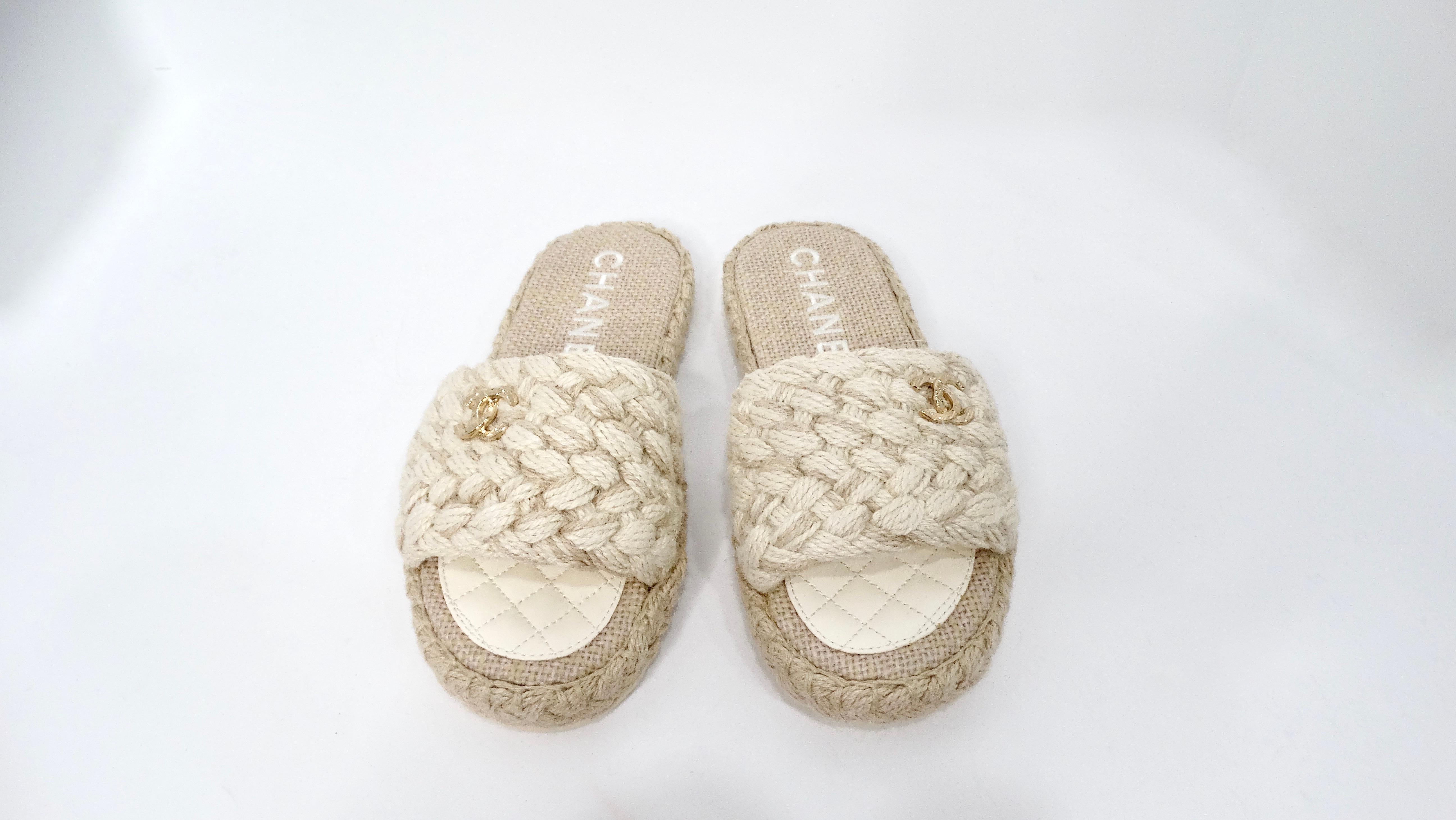 Chanel’s Beige Braided Cord Slide Sandals perfectly blend comfort and sophistication, making them an enchanting addition to any luxe wardrobe. Made from high-quality braided jute cord, these sandals feature an eye-catching gold-tone interlocking CC