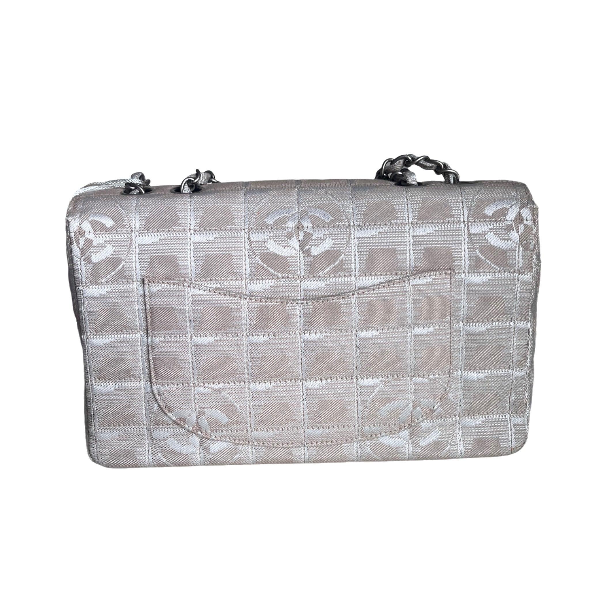 Chanel Beige Canvas Ice Cube Classic Flap 2000-2002 Shoulder Bag
  These are professional photos of the actual bag.
  This charming collectible and highly sought after Chanel Ice Cube 2006-2008 is a stylish mix of classy and casual. Featuring a