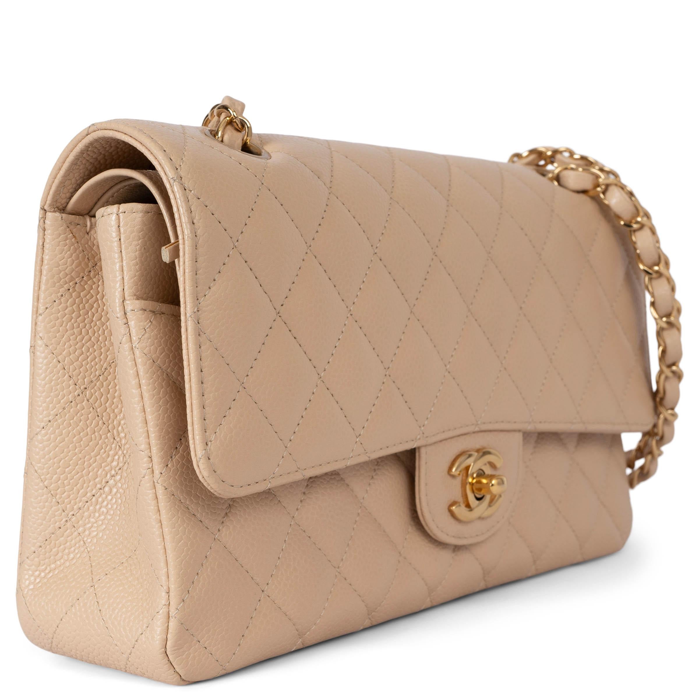 This 100% authentic Chanel Classic Medium 11.12 double flap shoulder bag is crafted from beige quilted Caviar leather with gold-tone hardware. It features an open outside pocket on the back and a classic double chain strap interlaced with leather.