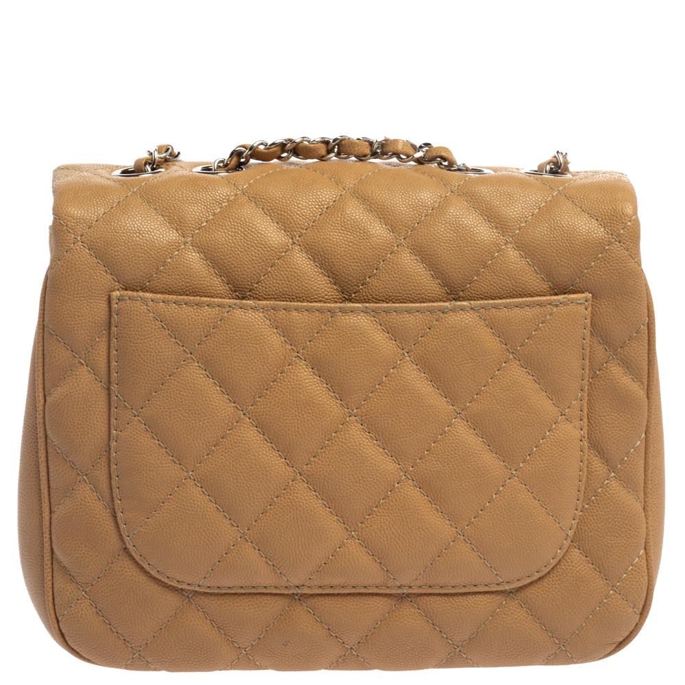 Diese Urban Companion Tasche von Chanel ist sehr schick und raffiniert! Die beigefarbene Tasche ist aus Kaviarleder gefertigt und weist das charakteristische Steppmuster auf der Außenseite auf. Sie ist mit dem ikonischen CC-Drehverschluss in Silber