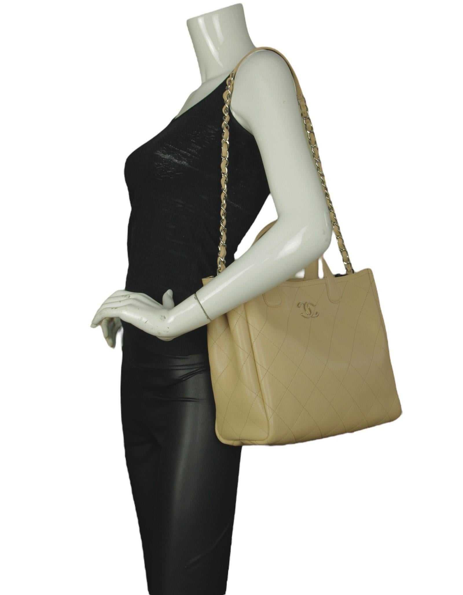 Chanel Beige Caviar Leather Quilted CC Tote Bag w/ Shoulder Strap

Made In: Italy
Year of Production: 2019
Color: Beige
Hardware: Silvertone
Materials: Caviar leather
Closure/Opening: Open top with center magnet
Exterior Pockets: None
Interior
