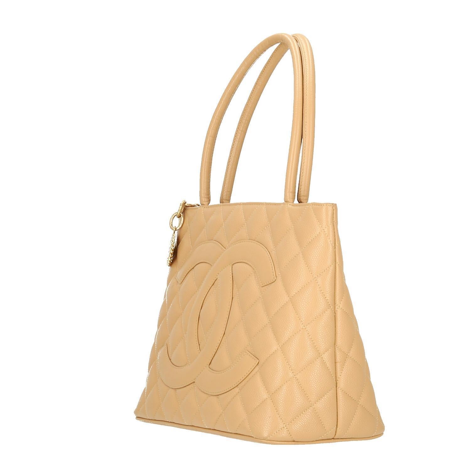 Chanel  Beige Caviar Leather Medallion  Shoulder Bag
This CHANEL tote is like new! 
It is in perfect condition, and the most beautiful rich Beige color! 
The rose gold medallion on the Chanel tote bag is attached to the zipper and features a pocket