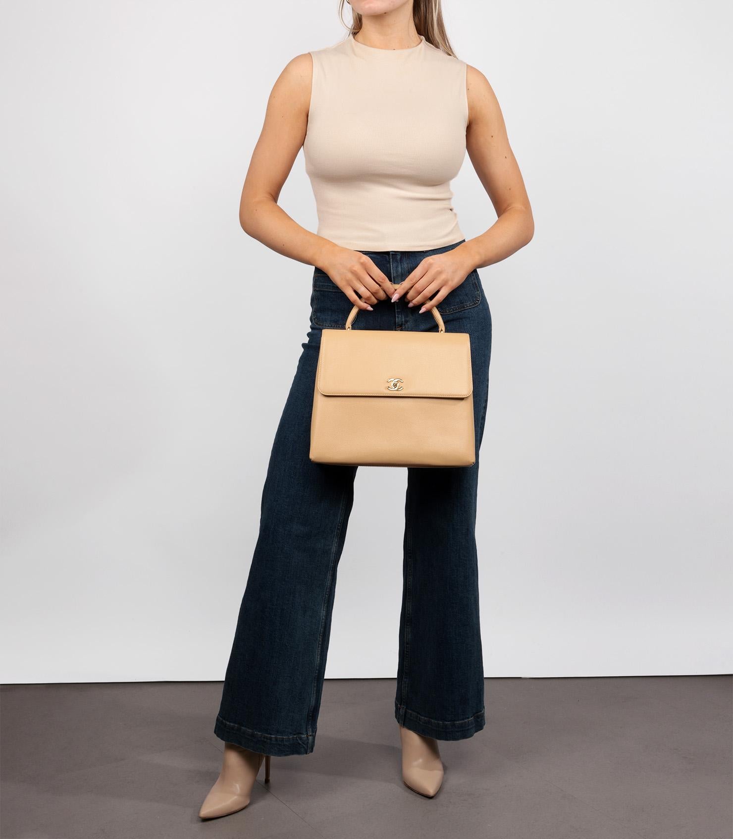 Chanel  Beige Caviar Leather Vintage Classic Kelly

Product Details
Xupes Ref: HB5531
Brand: Chanel 
Model: Classic Kelly
Type: Top Handle
Serial Number: 5577780
Age: 1997
Accompanied By: Authenticity Card
Colour: Beige
Hardware: Gold (24k Plated)