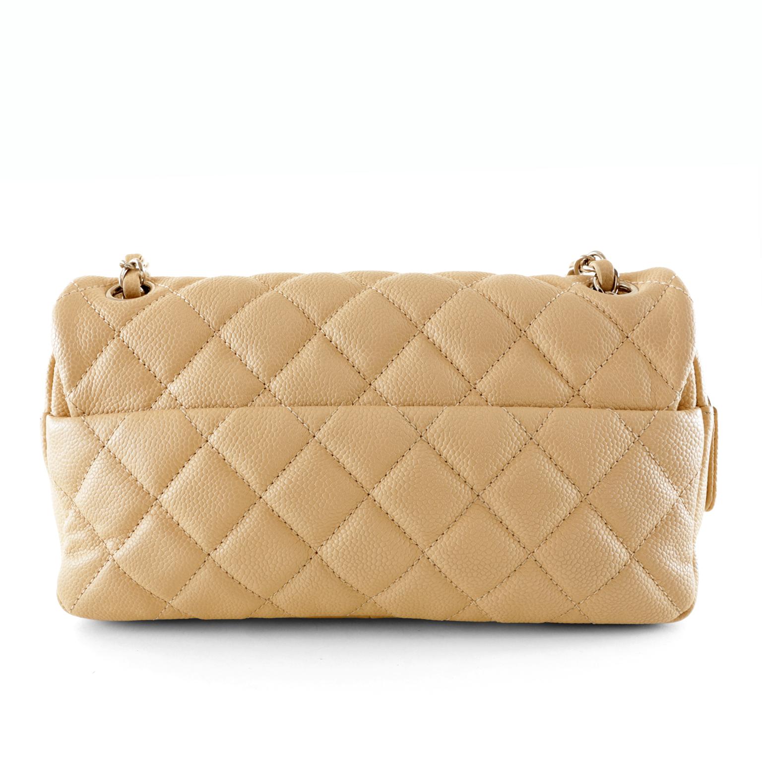 Chanel Beige Caviar Zipper Classic Bag- Pristine Condition
The perfect medium sized neutral bag, this Chanel complements every ensemble elegantly.  
Durable beige caviar leather is quilted in signature Chanel diamond pattern.  Silver interlocking CC