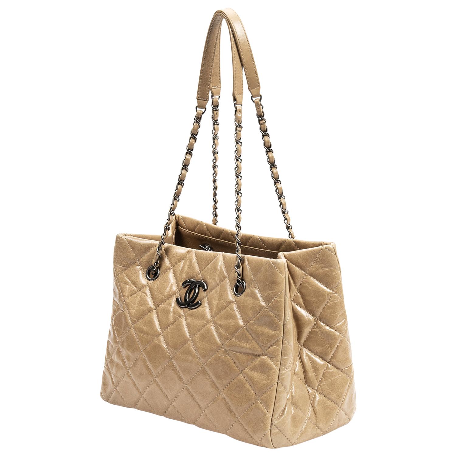 Beige is the new black! Super rare tan/beige quilted crinkled calfskin tote from 2014, crafted in leather, ruthenium hardware, the iconic CC logo plate, dual interwoven shoulder straps with shoulder rests and protective metal feet. This beauty opens