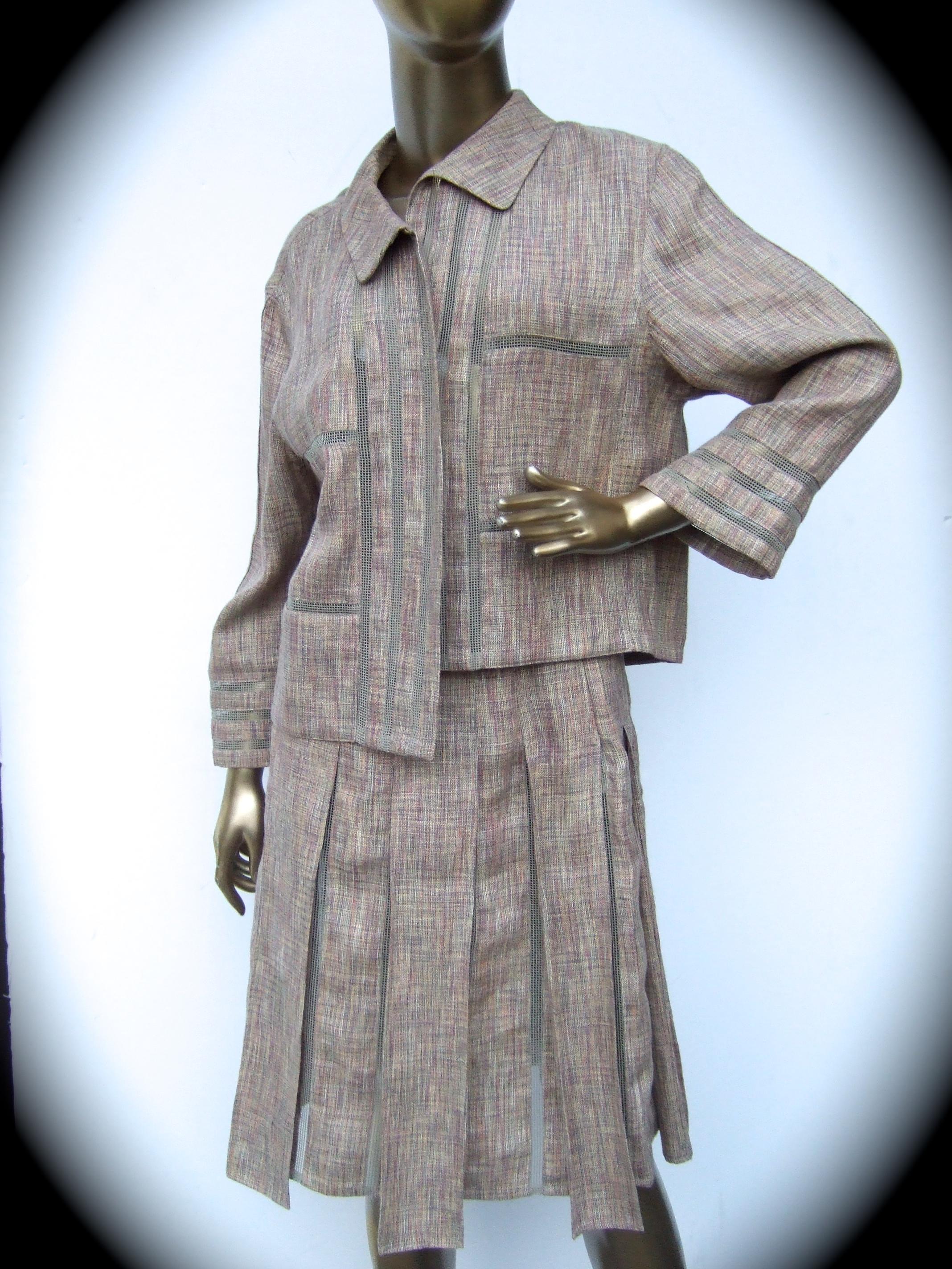 Chanel Chic beige linen & cotton blend skirt suit.  French Size 40
The stylish linen blend skirt suit is designed with a loose boxy jacket
Paired with a matching wide pleaded skirt

The jacket & skirt are designed with light weight linen & cotton