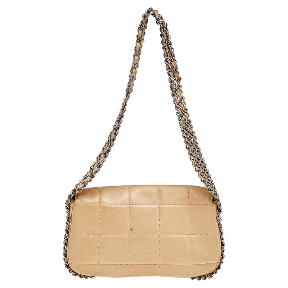 A bag to complement both Chanel lovers and handbag admirers is this one. It is made from leather and features a chocolate bar quilt on the exterior. The bag is held by multiple silver-tone chain handles and has a zipper that secures the nylon