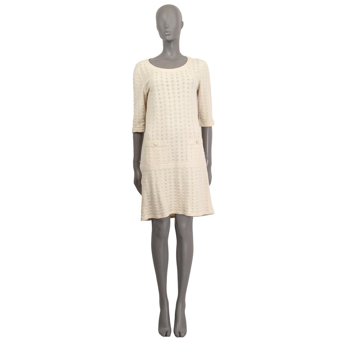 100% authentic Chanel short sleeve knitted drop-waist dress in sand cotton (100%) with a round neck and two decorative buttoned pockets on the front. Unlined. Has been worn and is in excellent condition. 

2013