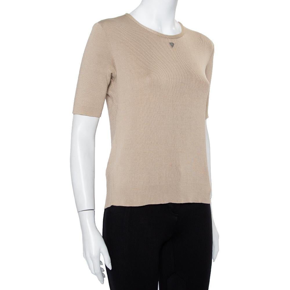 Comfortable clothing brought to you by Chanel. This beige T-shirt is knit using cotton into a simple casual design and finished with short sleeves and a brand plaque on the front. The Chanel T-shirt offers a good fit.

