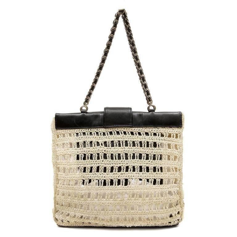 This authentic Chanel Beige Crocheted Tote is in excellent vintage condition.  The airy relaxed nature only adds to the extreme chic of this perfect warm weather bag. 
Beige crocheted body is trimmed with black leather and accented with dark silver