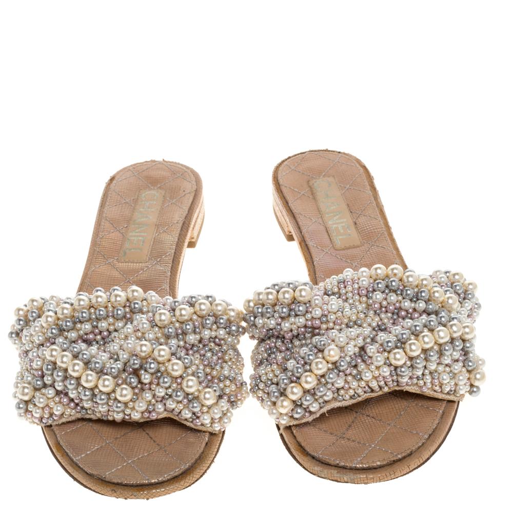 These flat slides from Chanel have been designed to deliver effortless style and comfort. Crafted in Italy, the lovely exterior is beautified with faux pearls. They are finished with leather insoles and durable soles.
