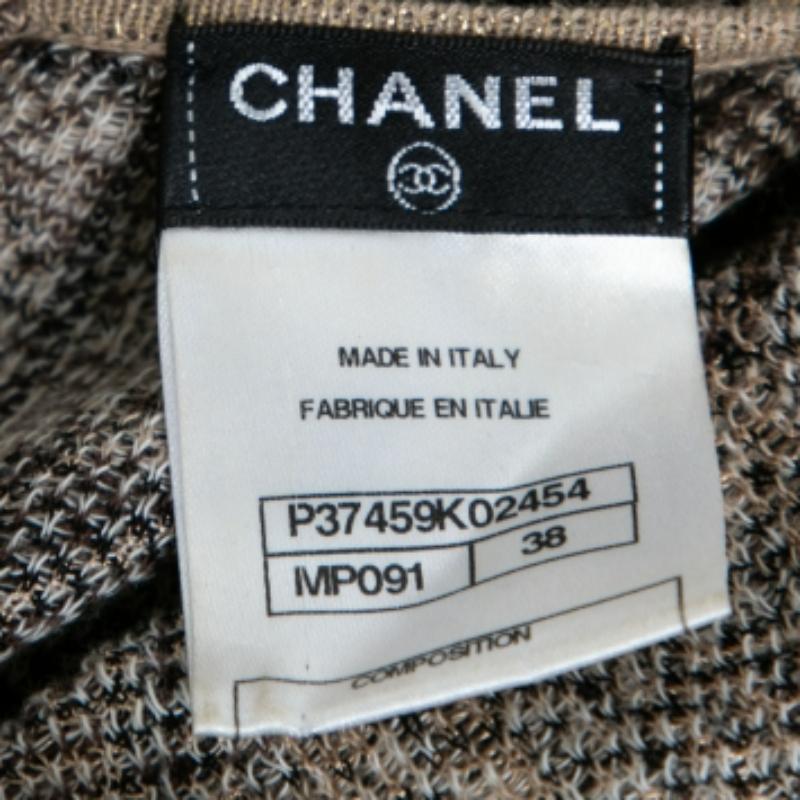 The House of Chanel brings you this stunning dress which is a perfect fit for your luxury wardrobe. It is fashioned in beige-gold jacquard knit fabric and is embellished with buttoned accents. It exhibits a sleeveless style and a zipper closure.
